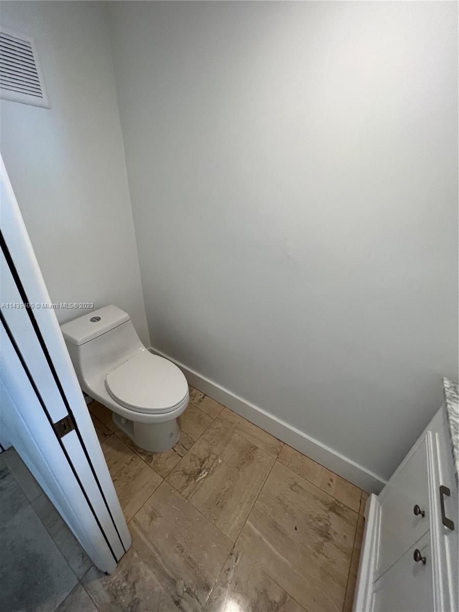 1915 Brickell Avenue, Unit TH16 Miami, FL 33129 - Photo 36 of 36 a white toilet sitting next to a shower