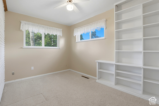 380 North 300 East Mapleton, UT 84664 - Photo 12 of 35 Built-in shelving, two windows with blinds, ceiling fan, and light-toned carpet
