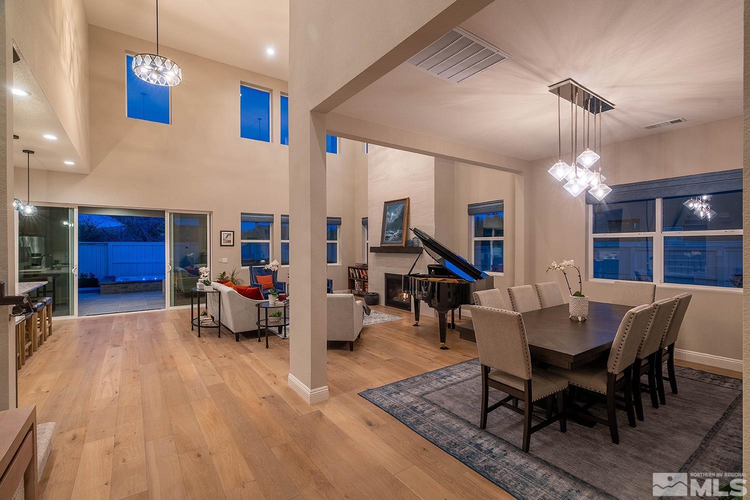 5414 Cremello Way Reno, NV 89511 - Photo 14 of 40 a living room with furniture a dining table and a chandelier