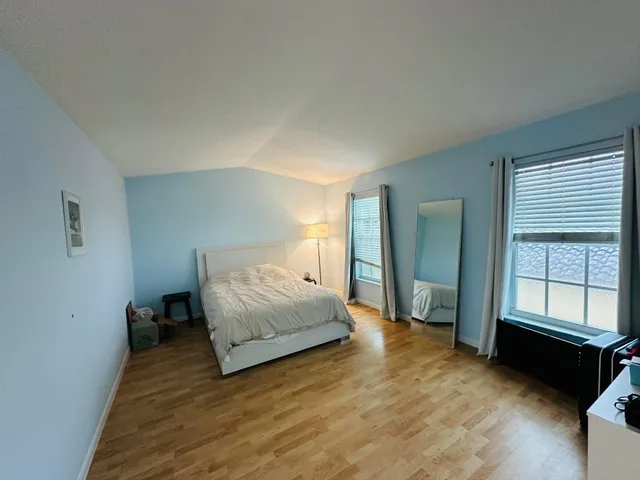 a spacious bedroom with a bed and window