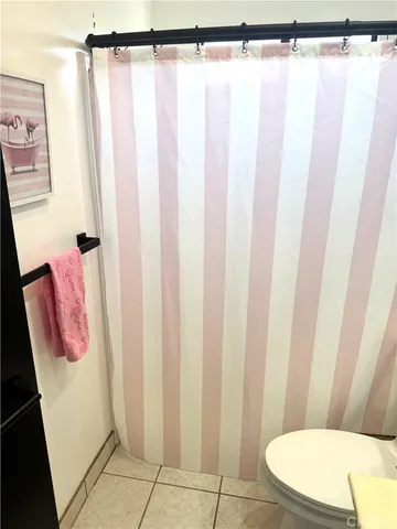 a bathroom with a shower curtain and sink