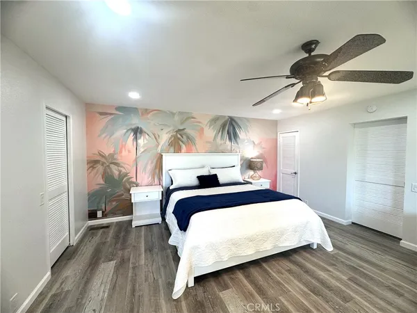 a bedroom with a bed and a mirror