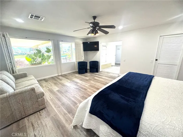 a bedroom with a large bed and a large window