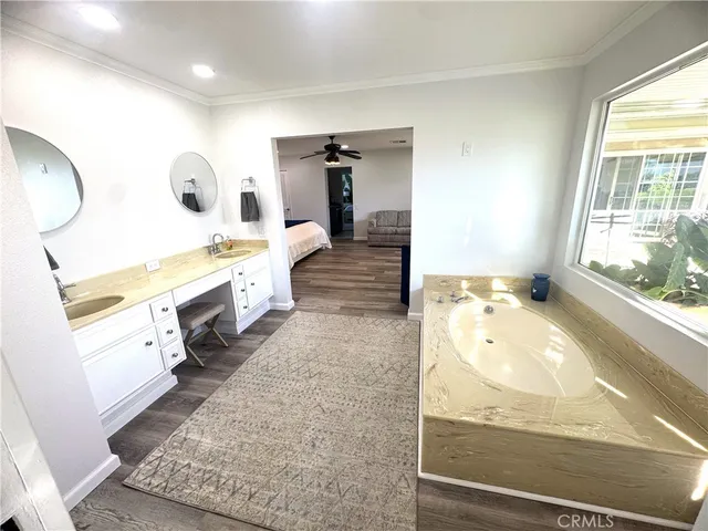 a bathroom with a tub sink and mirror
