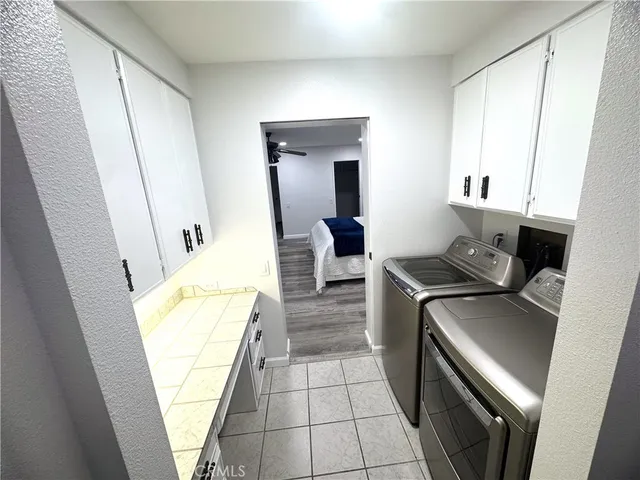 a kitchen with a sink and wooden floor