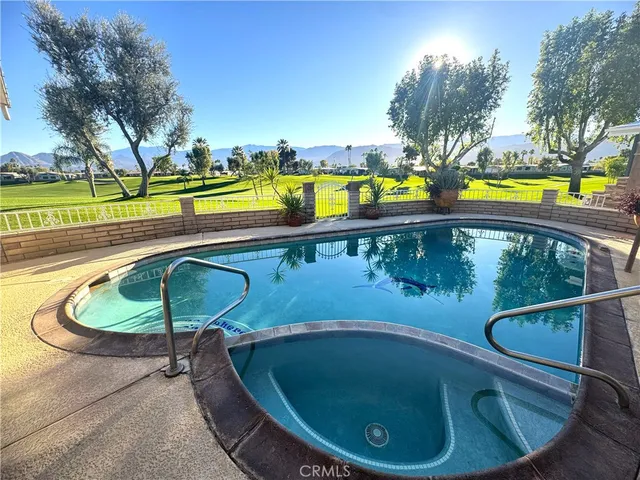 a view of swimming pool with a patio and yard