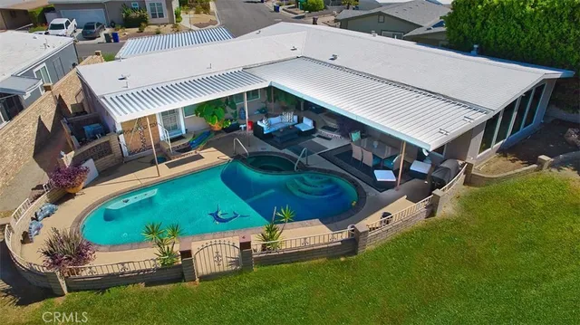 an aerial view of a house with a yard