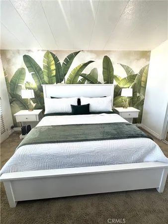 a living room with a bed and a painting on the wall