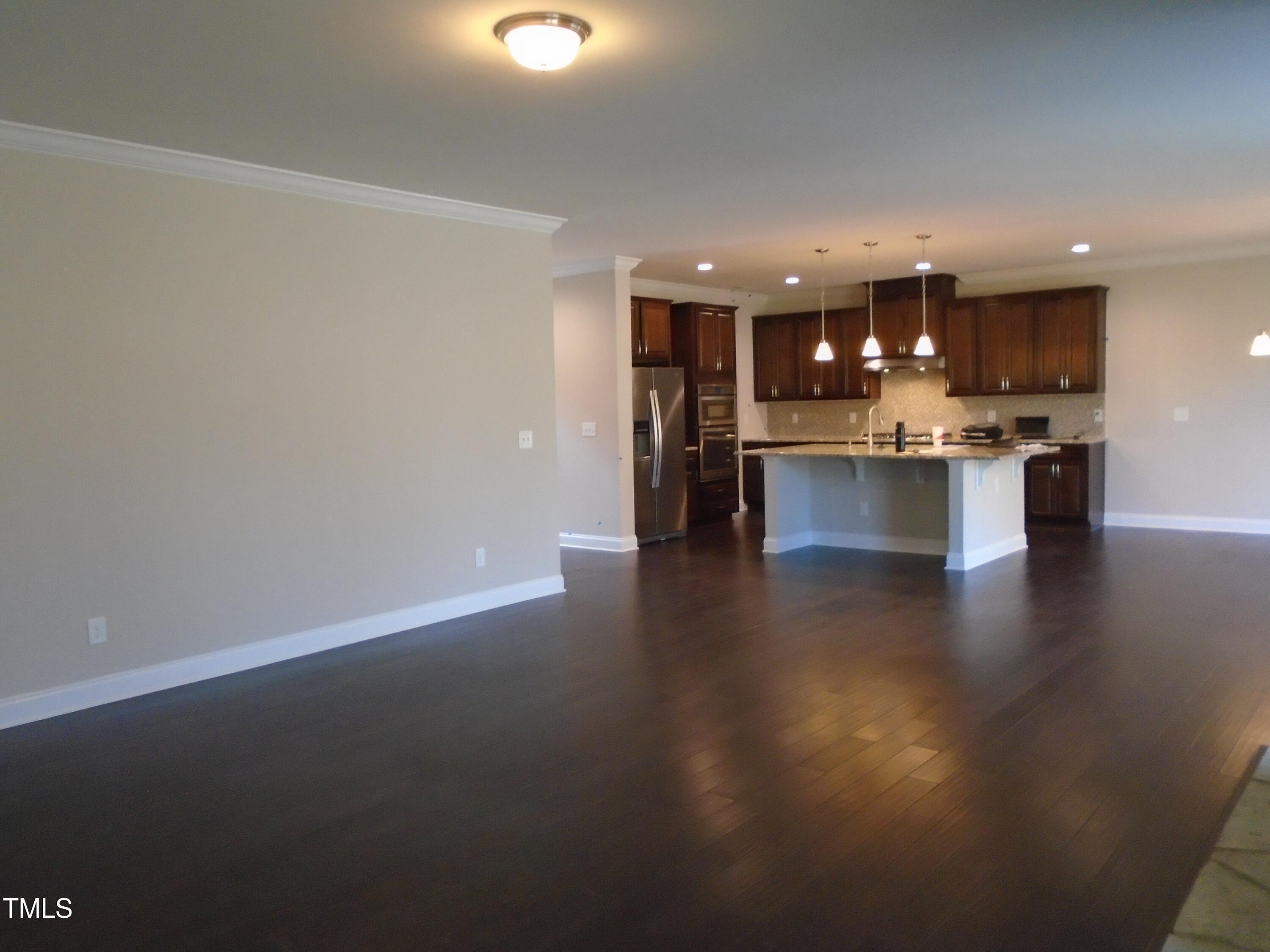 1809 Capstone Drive Durham, NC 27713 - Photo 12 of 35 a view of kitchen with kitchen island a sink wooden floor and a view of living room
