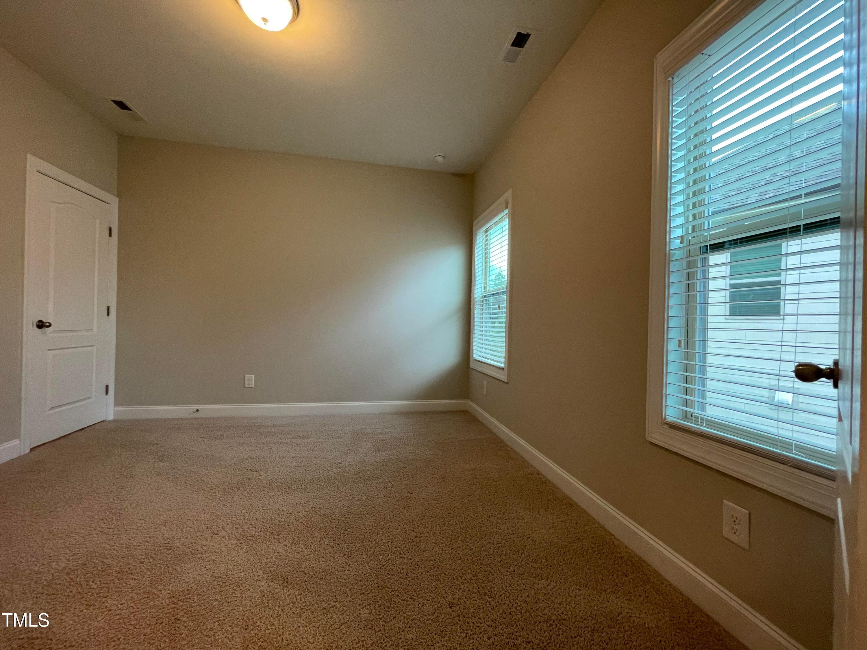 1809 Capstone Drive Durham, NC 27713 - Photo 19 of 35 a view of an empty room with a window
