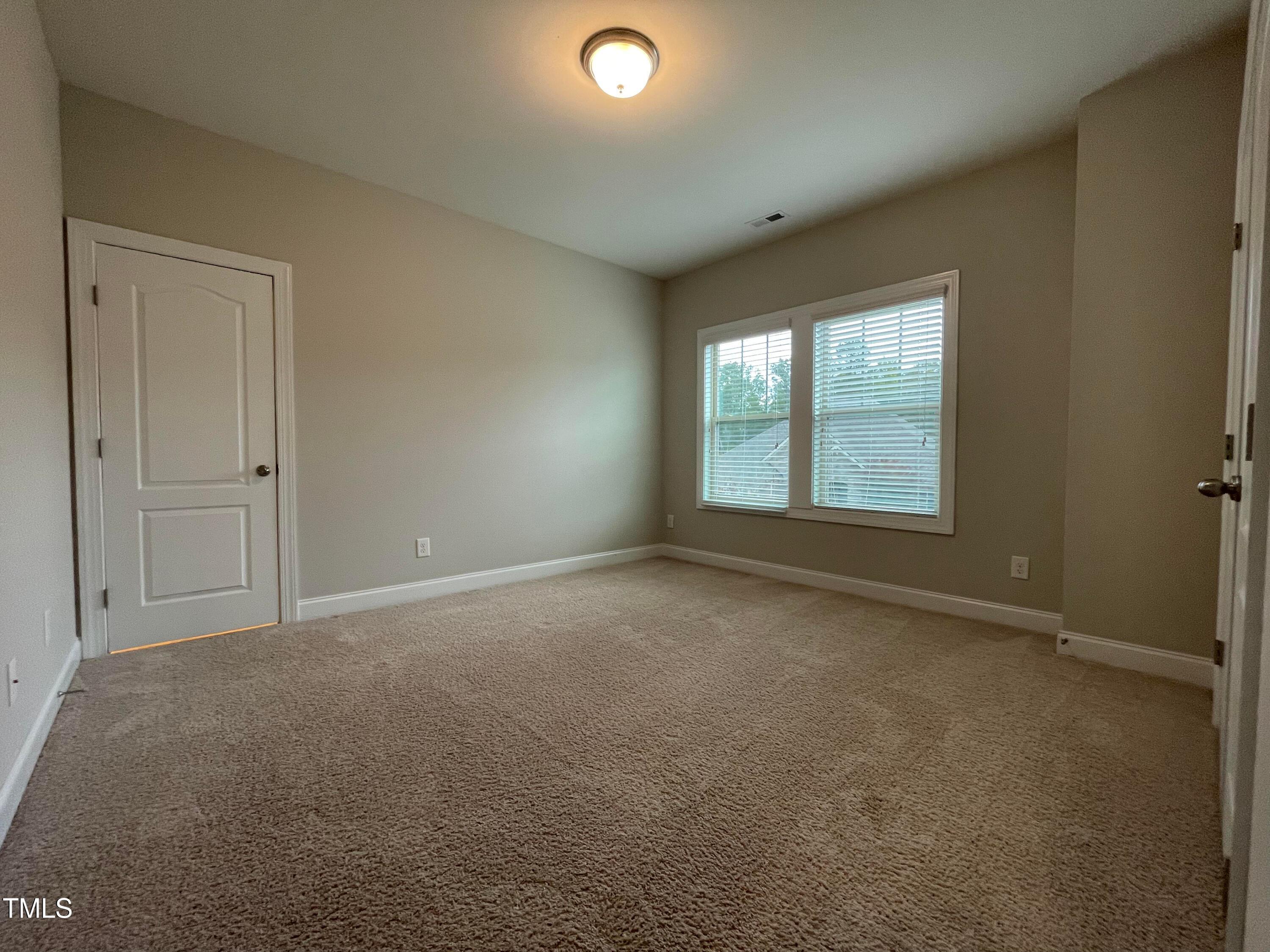 1809 Capstone Drive Durham, NC 27713 - Photo 22 of 35 an empty room with windows and closet