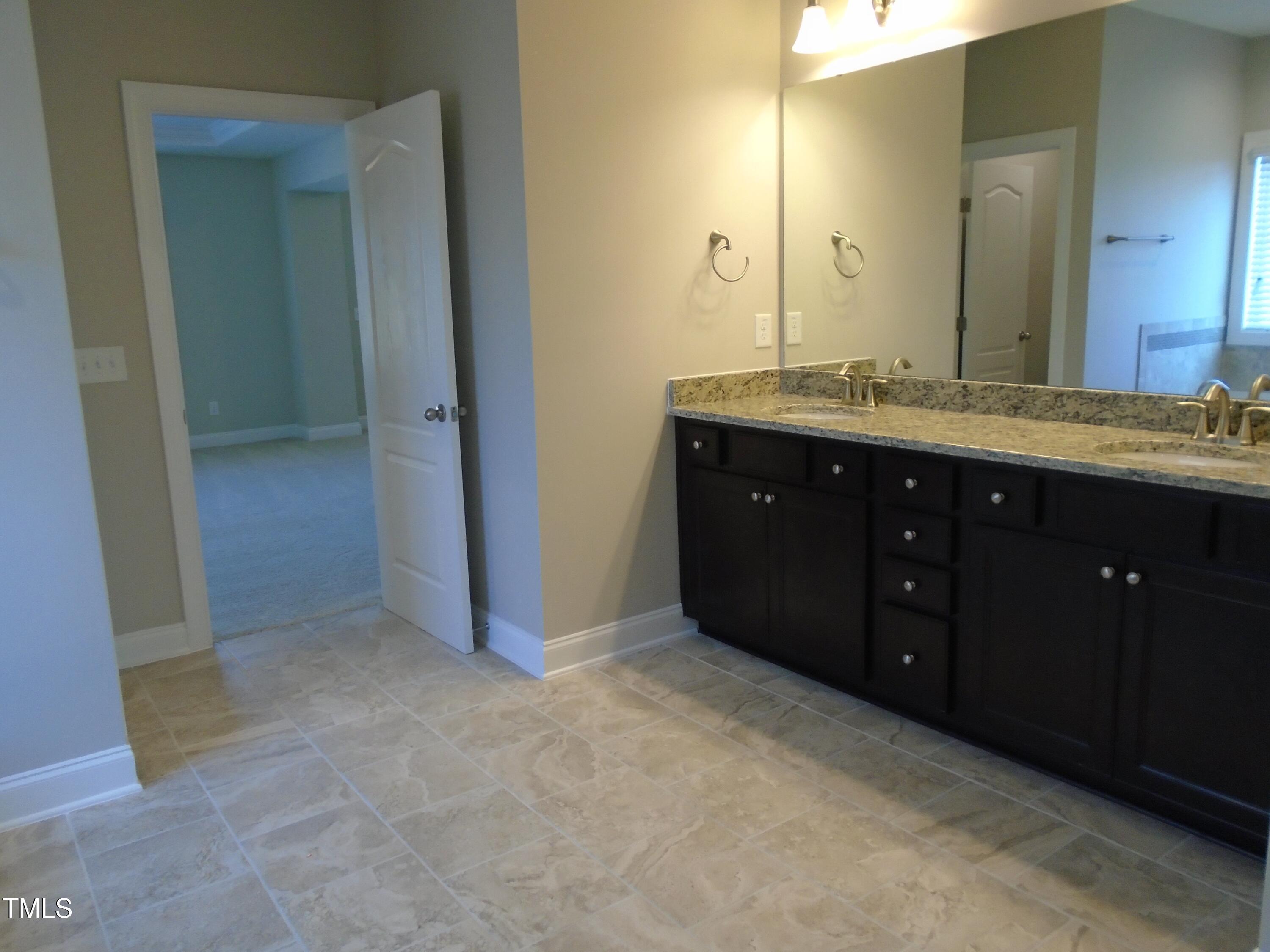 1809 Capstone Drive Durham, NC 27713 - Photo 28 of 35 a spacious bathroom with a double vanity sink and a mirror
