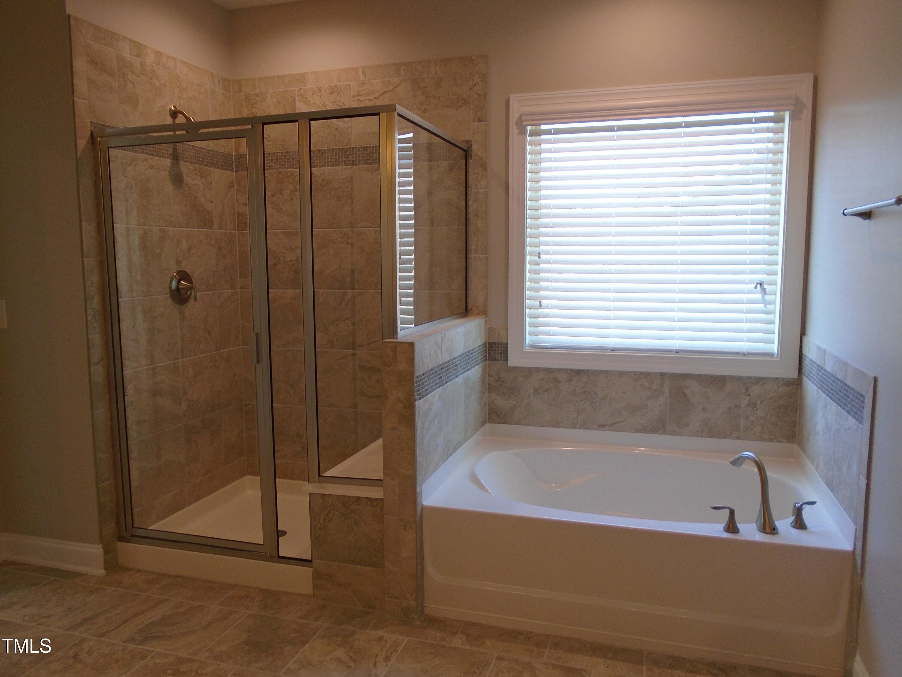 1809 Capstone Drive Durham, NC 27713 - Photo 30 of 35 a bathroom with a bathtub and a shower