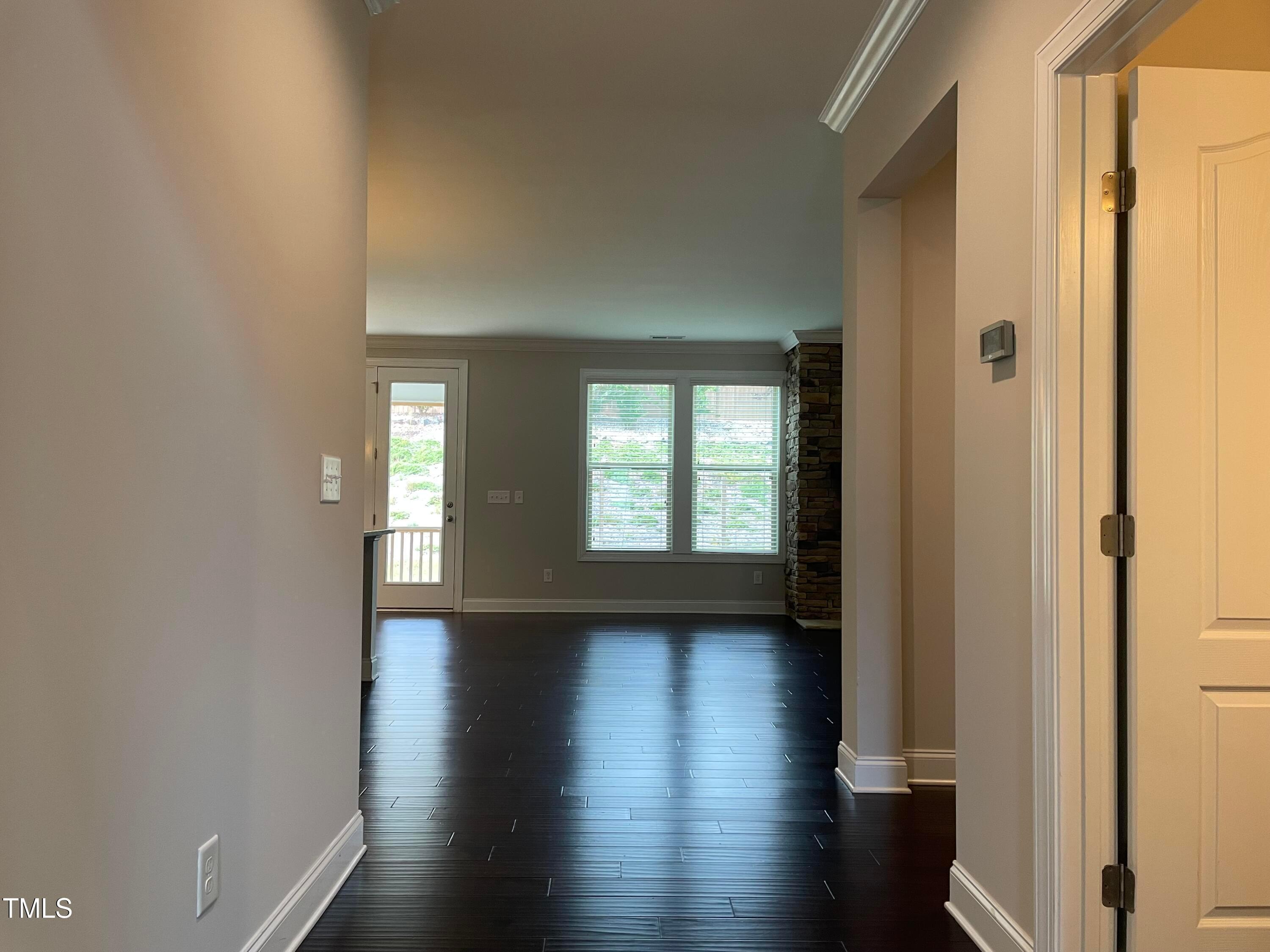 1809 Capstone Drive Durham, NC 27713 - Photo 6 of 35 a view of an empty room with glass door and wooden floor