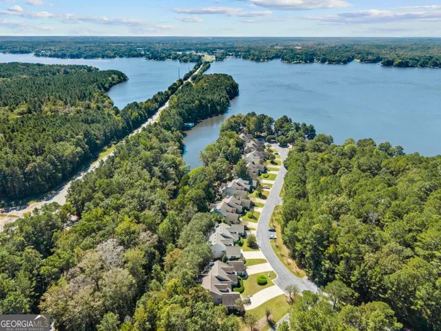 a living room with furniture a bookshelf and a window
