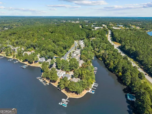 a view of a livingroom with furniture and a book shelf