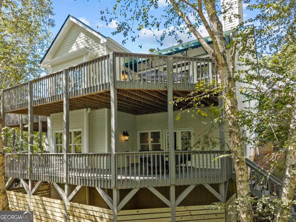 1540 Vintage Club Road Greensboro, GA 30642 - Photo 16 of 71 a view of a brick house with a small yard and wooden fence