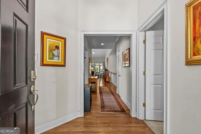 a kitchen with stainless steel appliances granite countertop wooden cabinets a sink and dishwasher with wooden floor