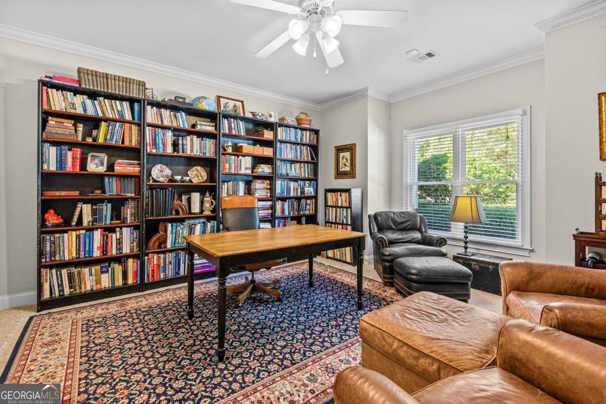 1540 Vintage Club Road Greensboro, GA 30642 - Photo 18 of 71 a living room with furniture a bookshelf and a window