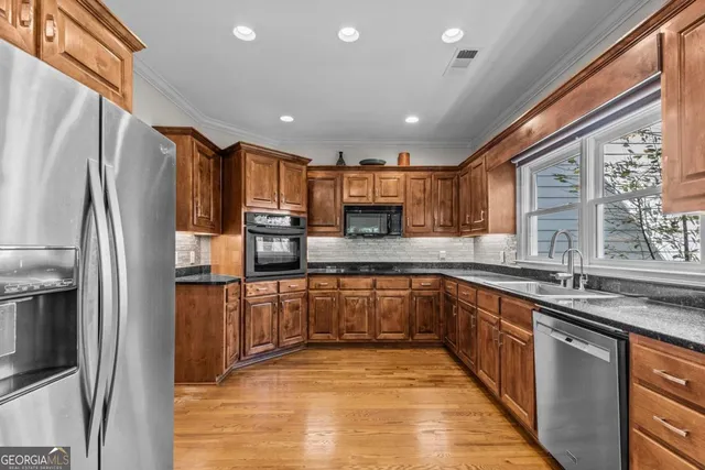 a bedroom with a bed couches chair and a large window