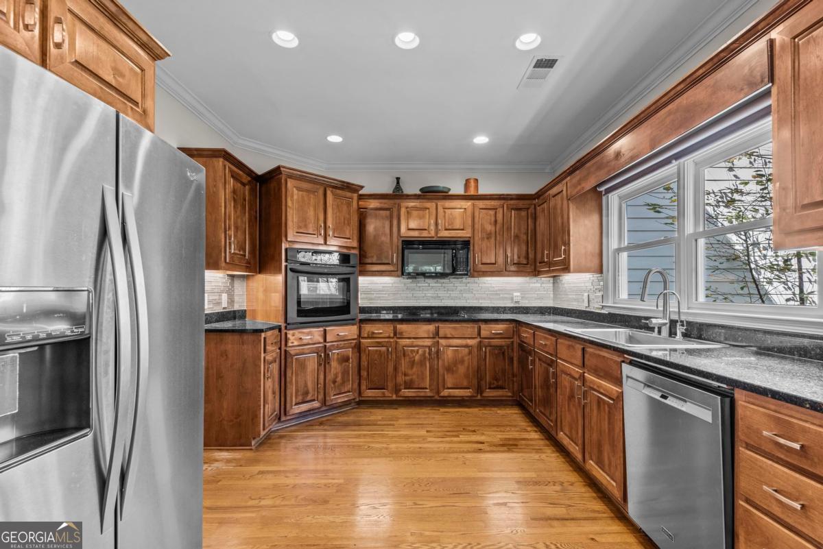 1540 Vintage Club Road Greensboro, GA 30642 - Photo 30 of 71 a large kitchen with stainless steel appliances granite countertop a refrigerator and a sink