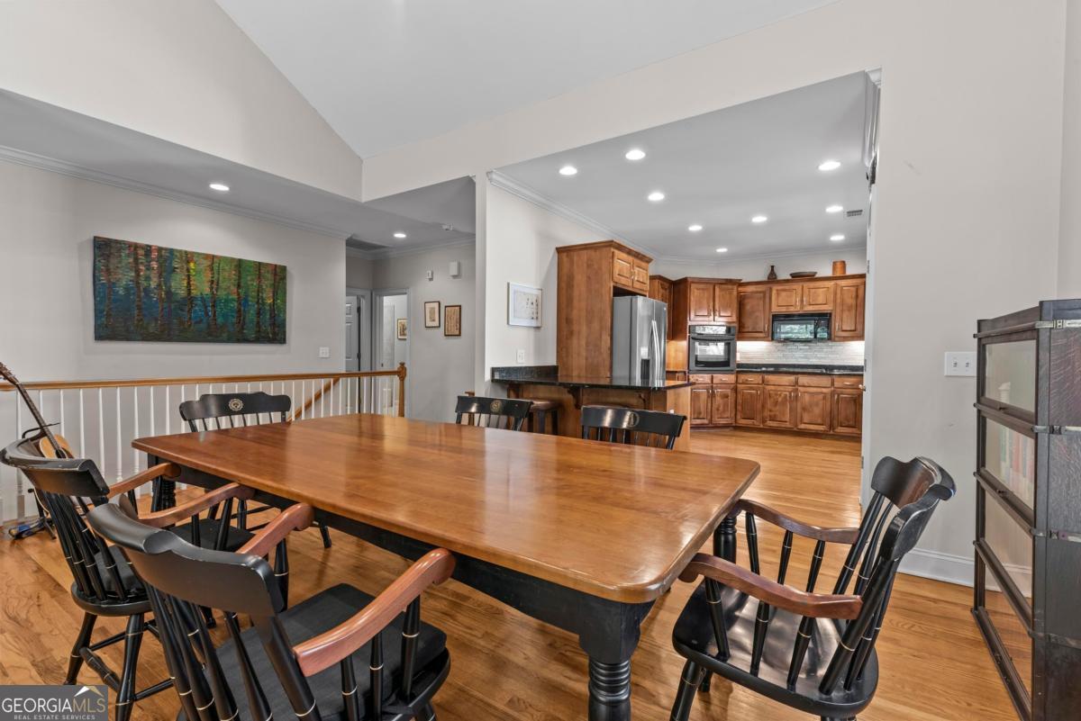 1540 Vintage Club Road Greensboro, GA 30642 - Photo 40 of 71 a dining room with furniture and wooden floor