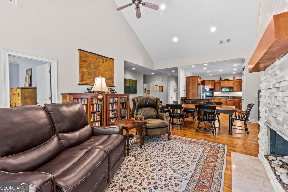 1540 Vintage Club Road Greensboro, GA 30642 - Photo 41 of 71 a living room with furniture a dining table and a piano