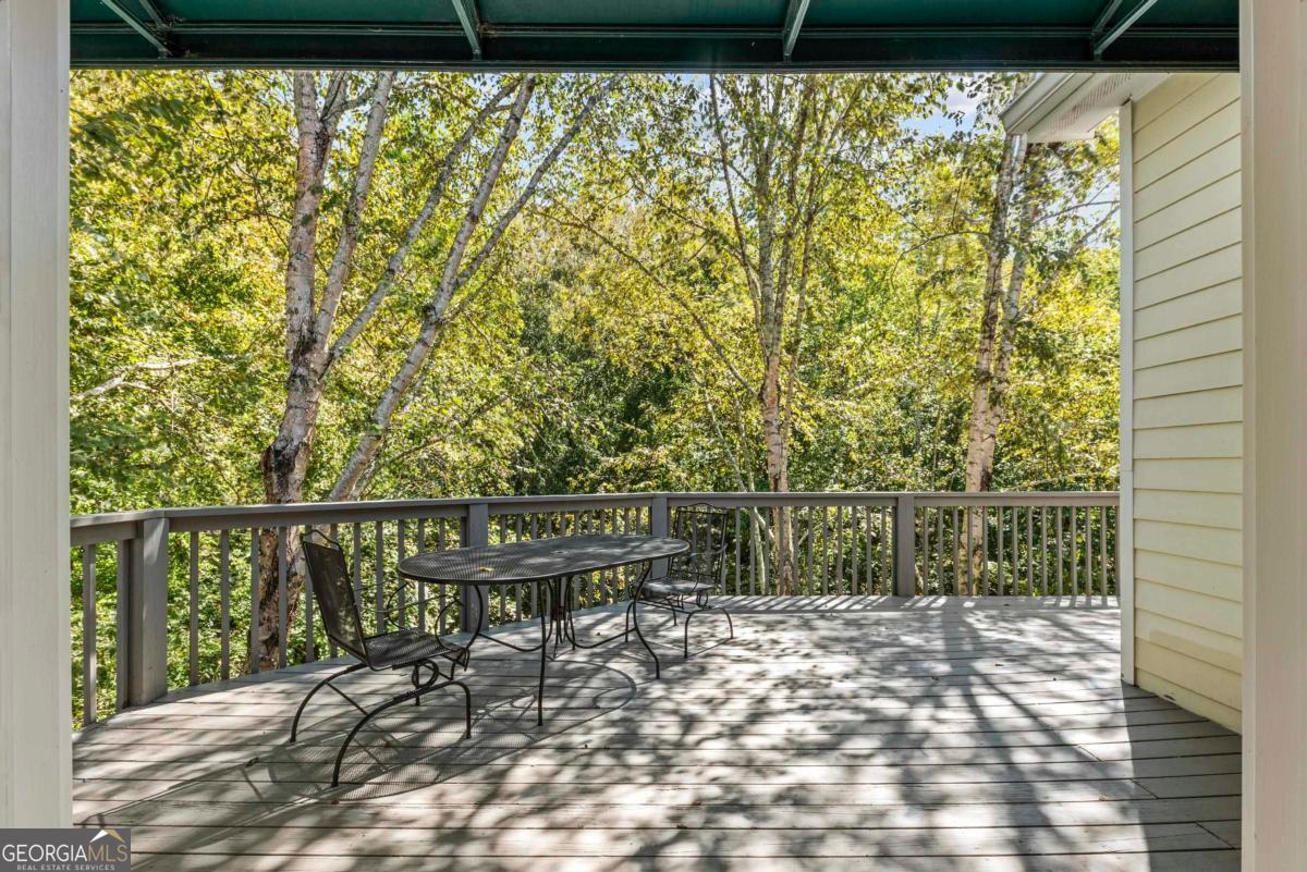 1540 Vintage Club Road Greensboro, GA 30642 - Photo 42 of 71 a view of a lake with a bench and wooden floor