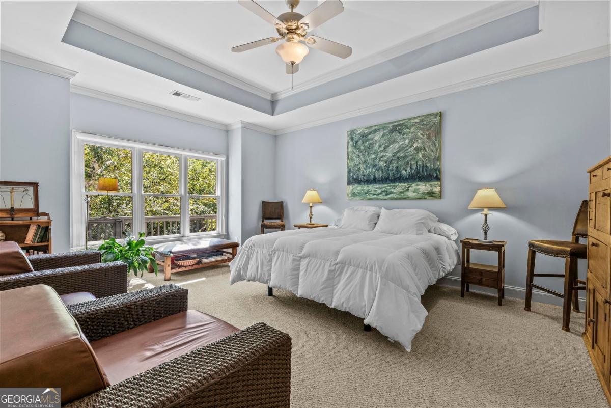 1540 Vintage Club Road Greensboro, GA 30642 - Photo 43 of 71 a bedroom with a bed couches chair and a large window