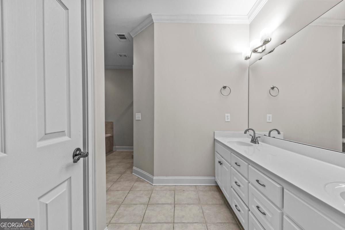 1540 Vintage Club Road Greensboro, GA 30642 - Photo 45 of 71 a spacious bathroom with a double vanity sink a mirror and a shower