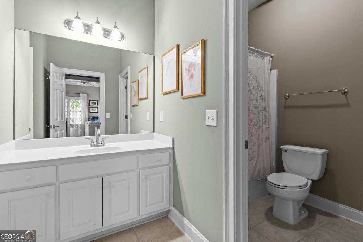 1540 Vintage Club Road Greensboro, GA 30642 - Photo 56 of 71 a bathroom with a toilet sink and mirror