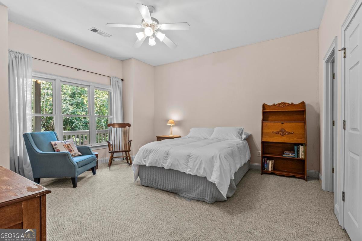 1540 Vintage Club Road Greensboro, GA 30642 - Photo 58 of 71 a spacious bedroom with a bed and a couch