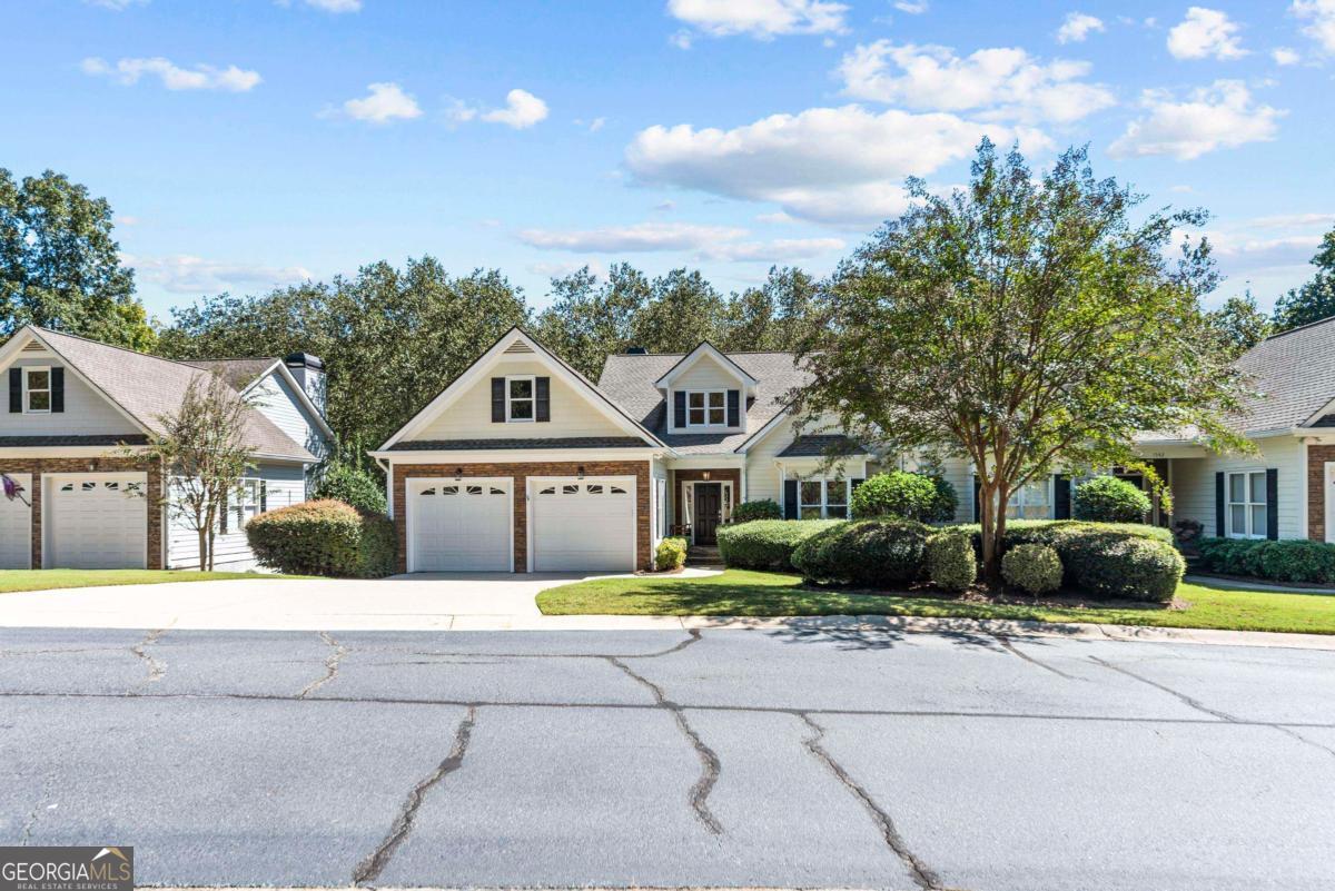 1540 Vintage Club Road Greensboro, GA 30642 - Photo 64 of 71 a front view of a house with a garden and trees