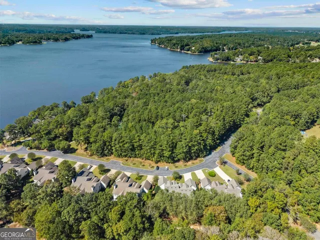a view of a hallway with wooden floor and dining room