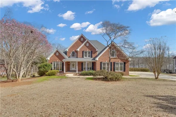 a front view of a house with a yard and covered with snow