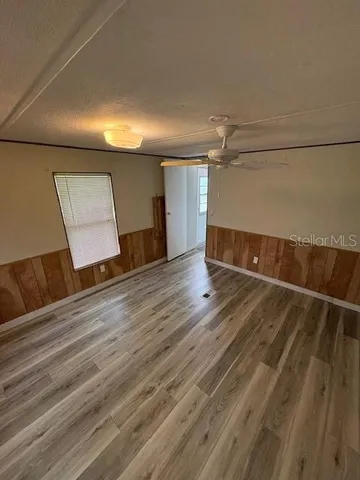 a view of an empty room with wooden floor