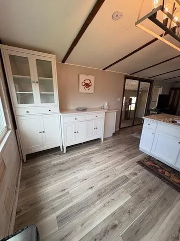a view of a bedroom with furniture and window