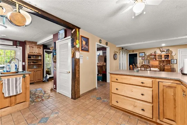 a living room with furniture a chandelier and a dining table