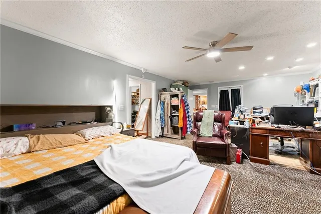 a view of walk in closet with clothes