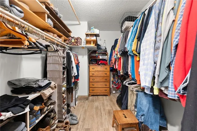 a living room with furniture a flat screen tv and a large window