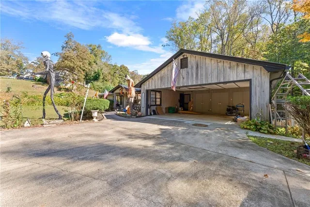 a view of a house with backyard and sitting area