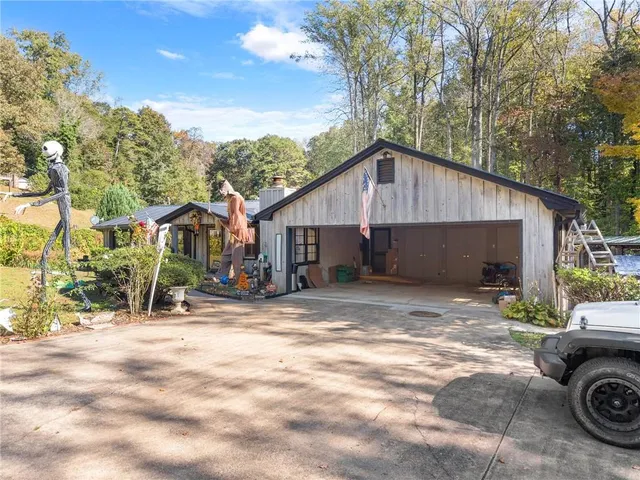 a view of a house with backyard and sitting area