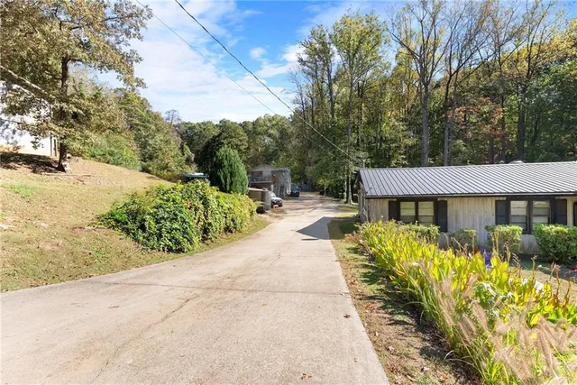 a view of a patio with couches table and chairs with wooden fence and floor