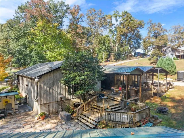 a view of a dining room with furniture large windows and wooden floor
