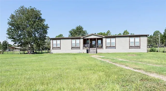 a front view of a house with a garden and porch