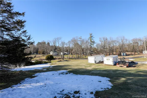 a view of a yard with swimming pool and trees