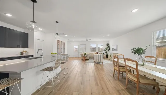 a large kitchen with a table and chairs