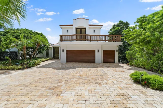a view of house with swimming pool and outdoor seating
