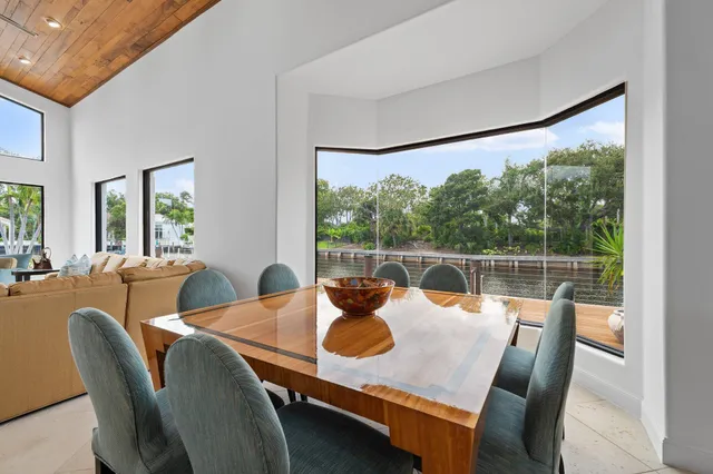 a view of a lake with boats and palm trees