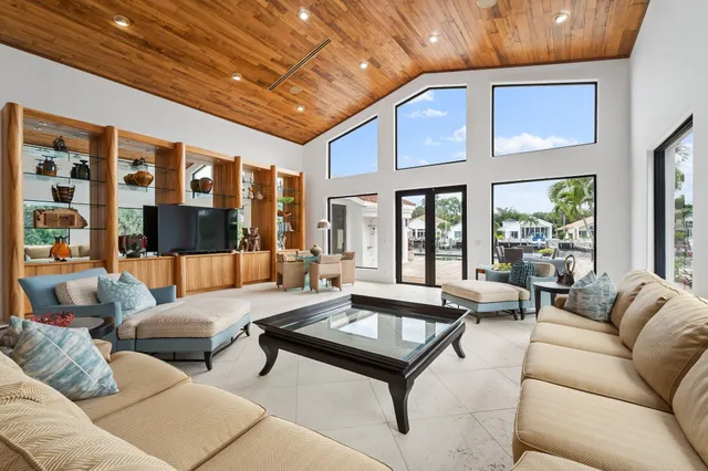 a view of a patio with table and chairs potted plants and palm trees
